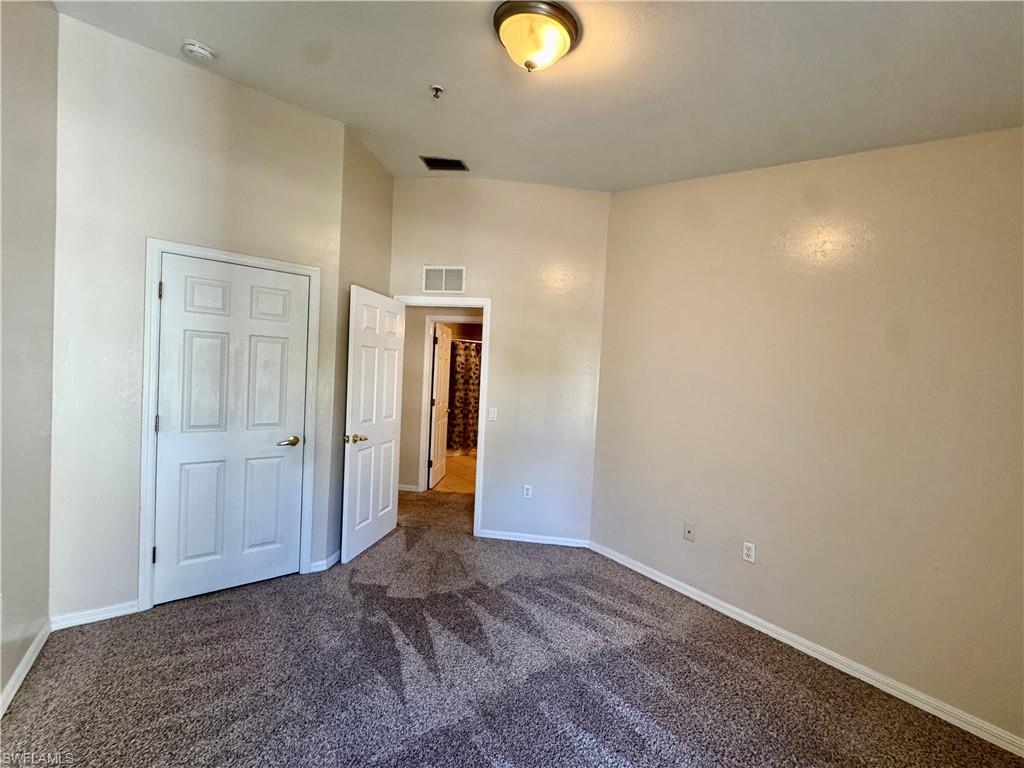 912 Hampton Circle, Unit 92 Naples, FL 34105 - Photo 19 of 31 Unfurnished bedroom featuring carpet and baseboards