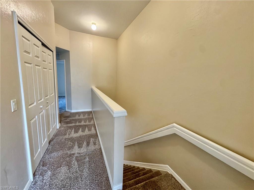 912 Hampton Circle, Unit 92 Naples, FL 34105 - Photo 9 of 31 Hall with carpet floors and an upstairs landing