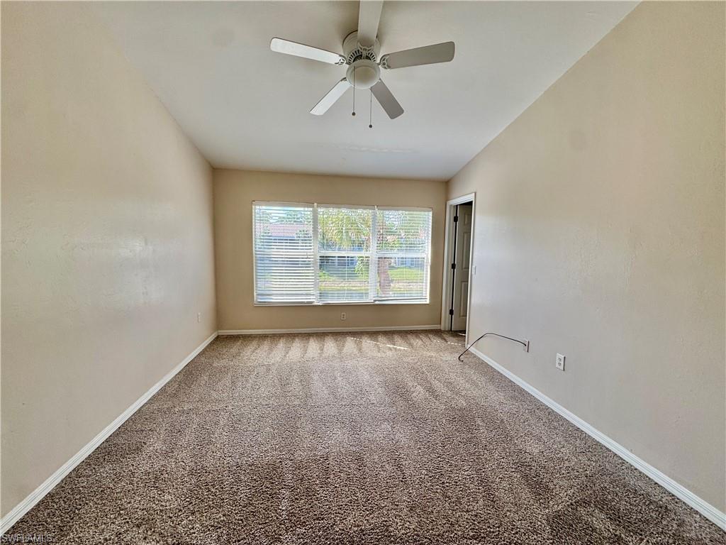 912 Hampton Circle, Unit 92 Naples, FL 34105 - Photo 10 of 31 Carpeted empty room with baseboards and a ceiling fan