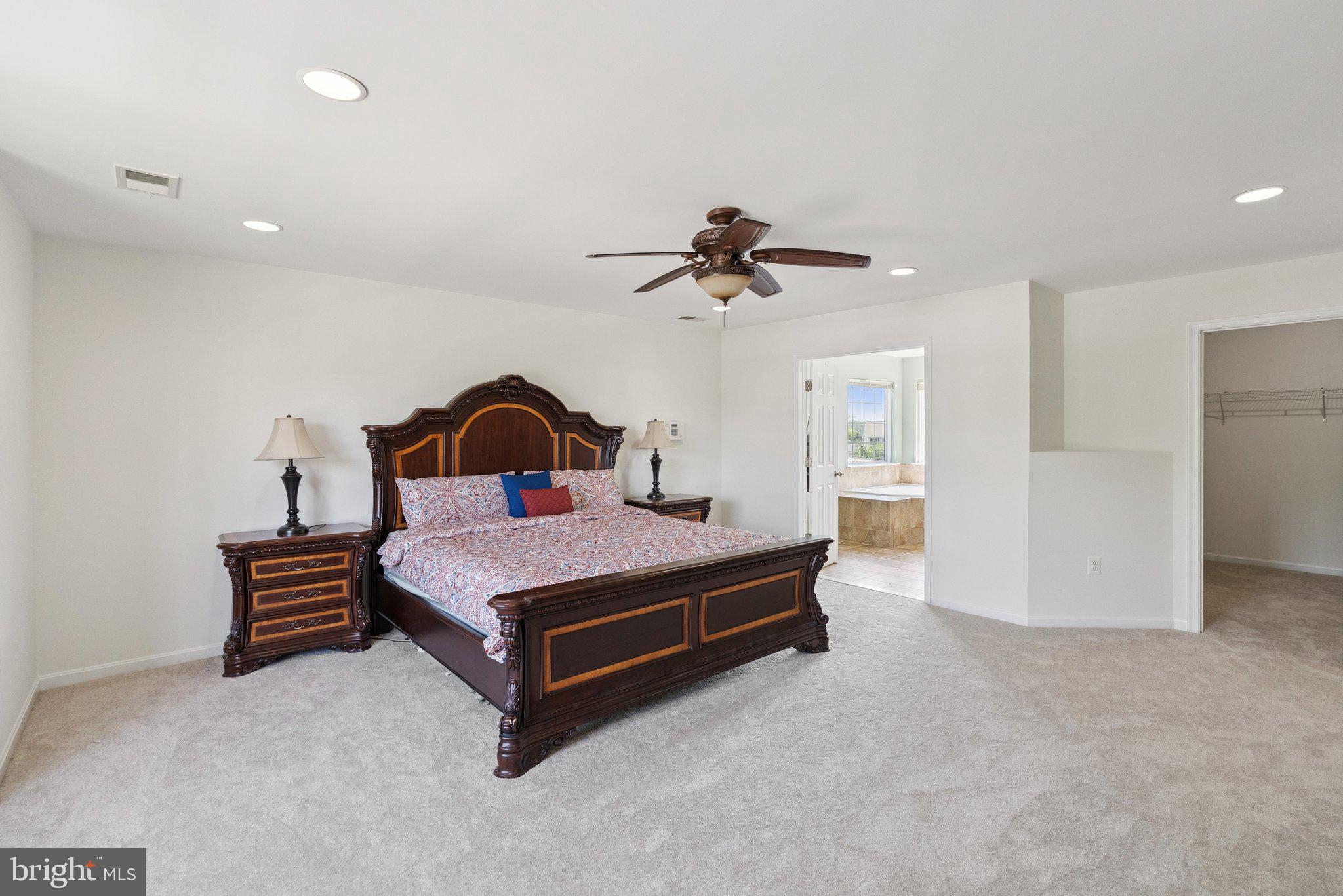 5402 Loggerhead Place Woodbridge, VA 22193 - Photo 15 of 40 a bedroom with a bed and a ceiling fan