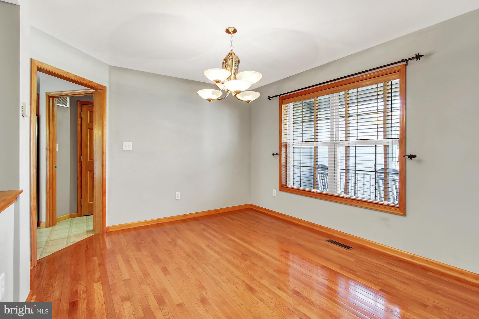 Dining Room w/ Hardwood Floors & Large Window