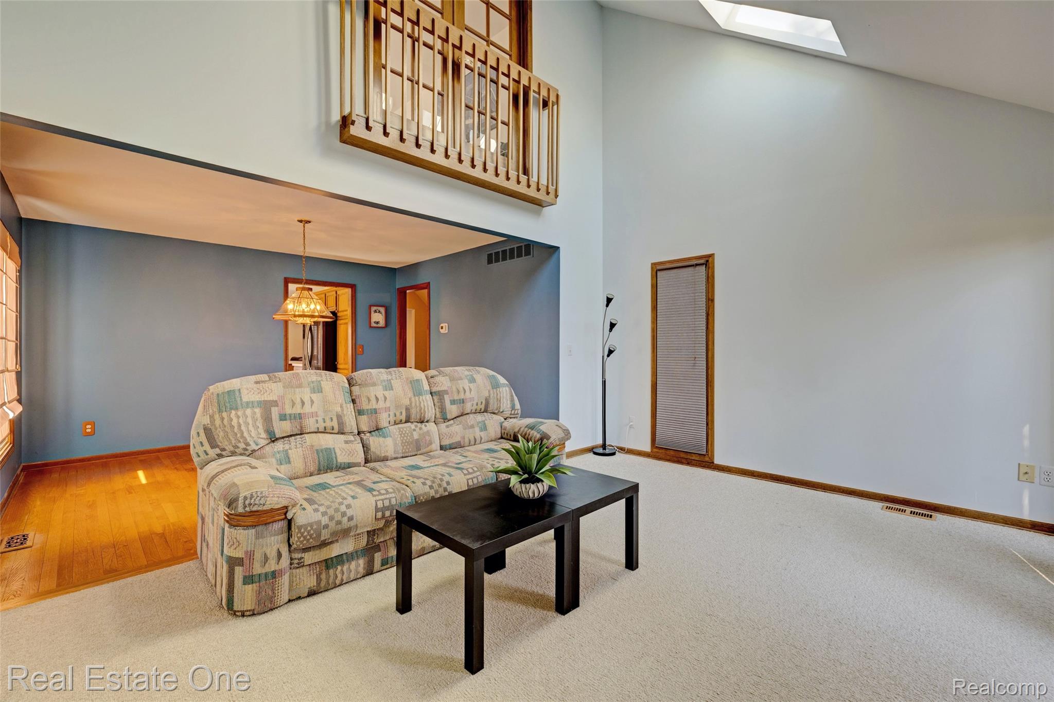 6400 Oakhill Road Ortonville, MI 48462 - Photo 14 of 82 Living area with a high ceiling, carpet floors, and a skylight