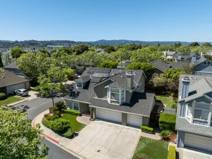 an aerial view of a house with a yard