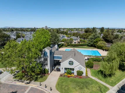 an aerial view of a house with a yard and lake view