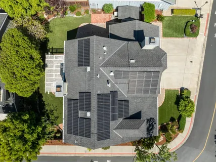 an aerial view of a house with a yard and potted plants