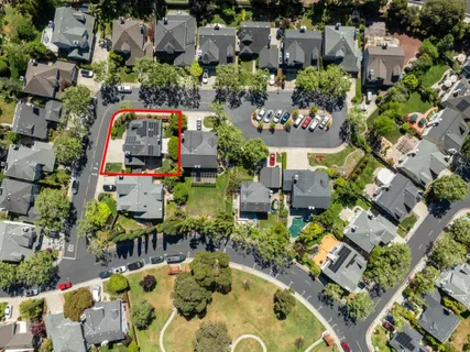 an aerial view of a house with a swimming pool yard and outdoor seating