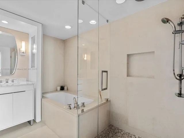 a bathroom with a shower a sink and a mirror