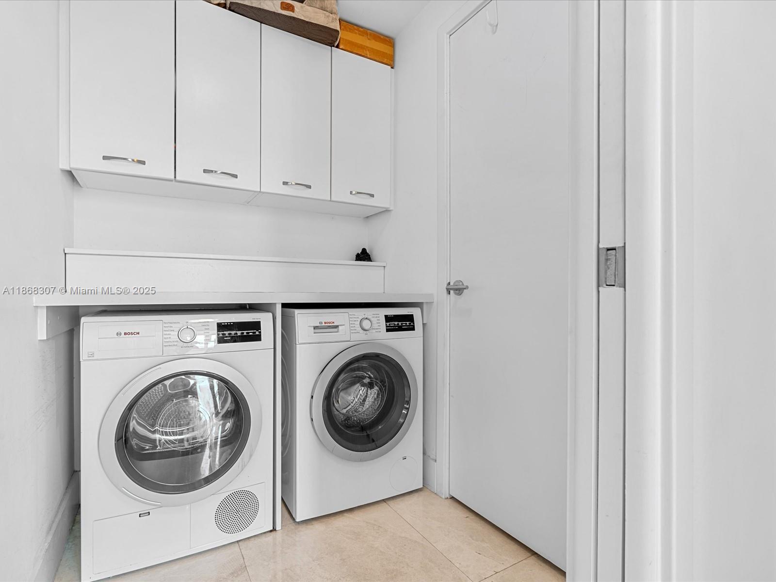 6899 Collins Avenue, Unit 1010 Miami Beach, FL 33141 - Photo 23 of 37 a utility room with dryer and washer