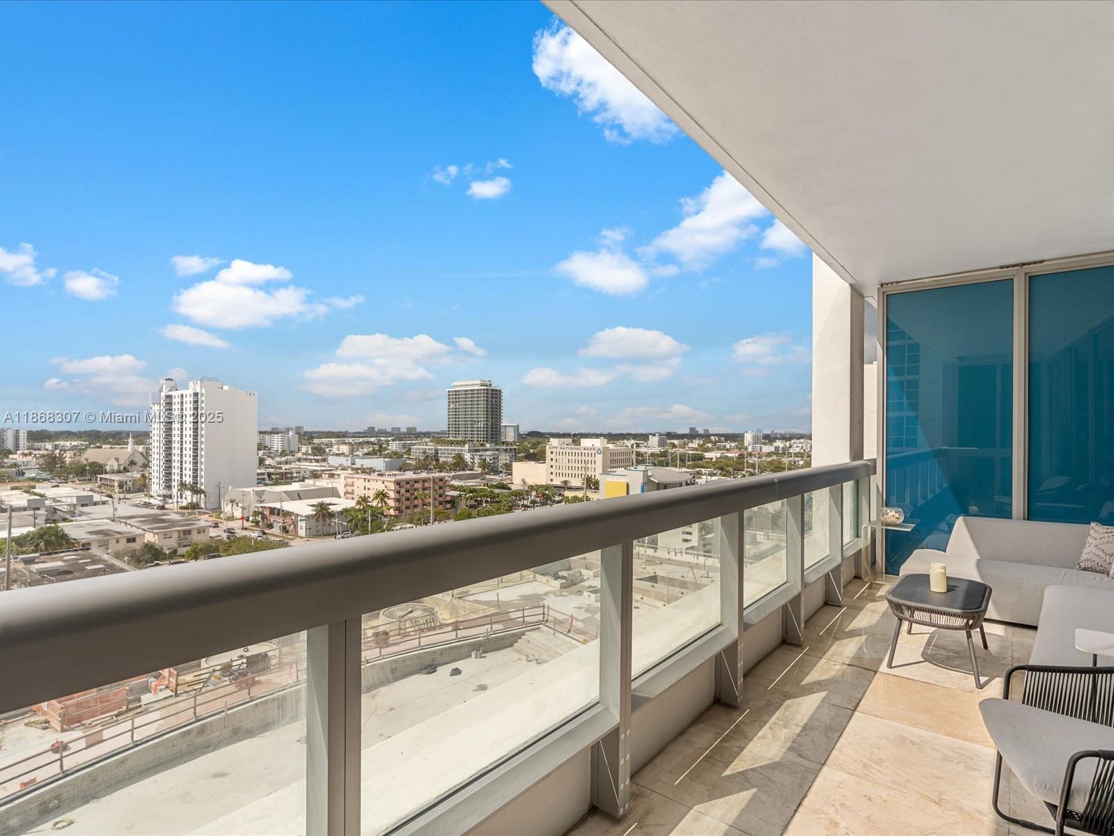 6899 Collins Avenue, Unit 1010 Miami Beach, FL 33141 - Photo 25 of 37 a view of a city from a balcony with furniture