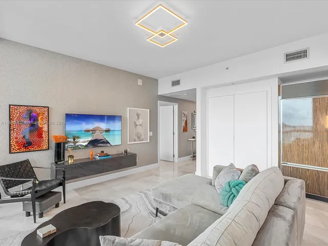 a bedroom with furniture and a large window