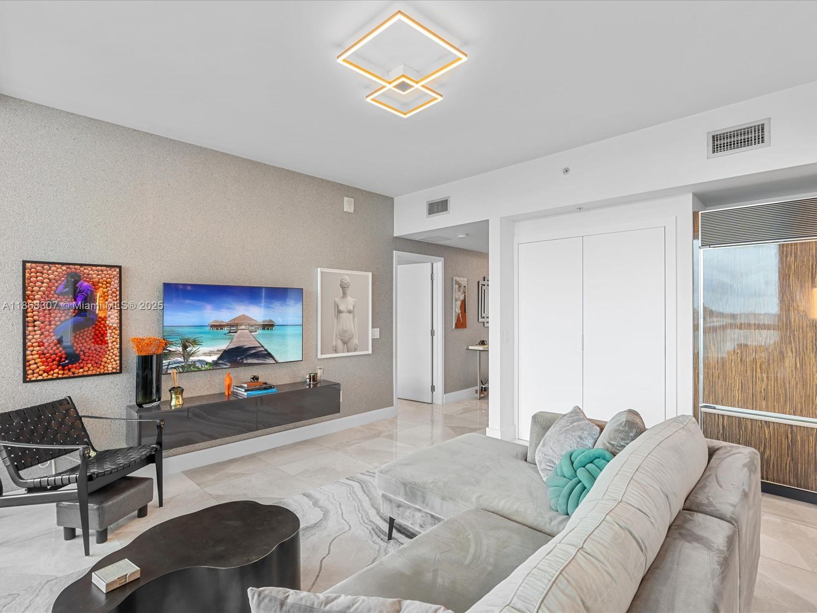 6899 Collins Avenue, Unit 1010 Miami Beach, FL 33141 - Photo 5 of 37 a bedroom with furniture and a large window