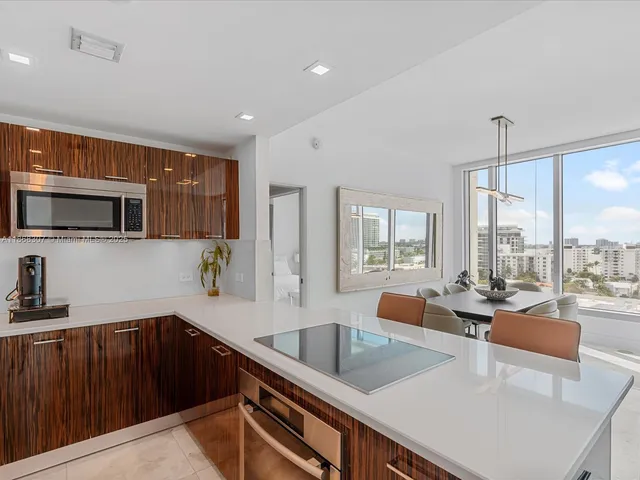 a kitchen with granite countertop a sink and a stove top oven