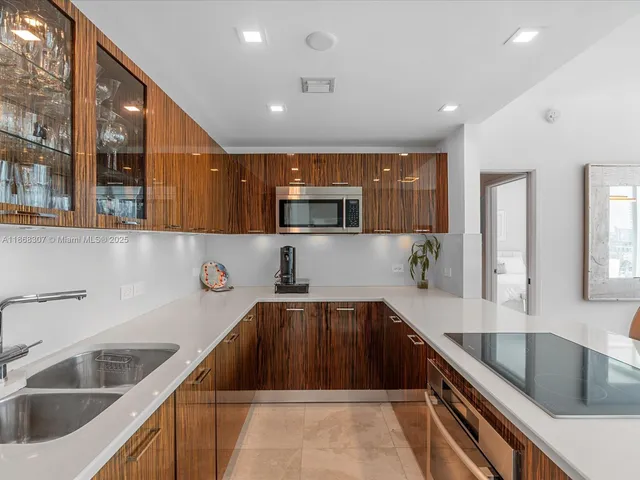 a kitchen with granite countertop a sink and a stove top oven