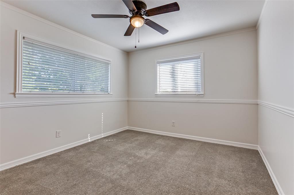 110 Ocean Drive Richardson, TX 75081 - Photo 13 of 20 an empty room with a window and a fan