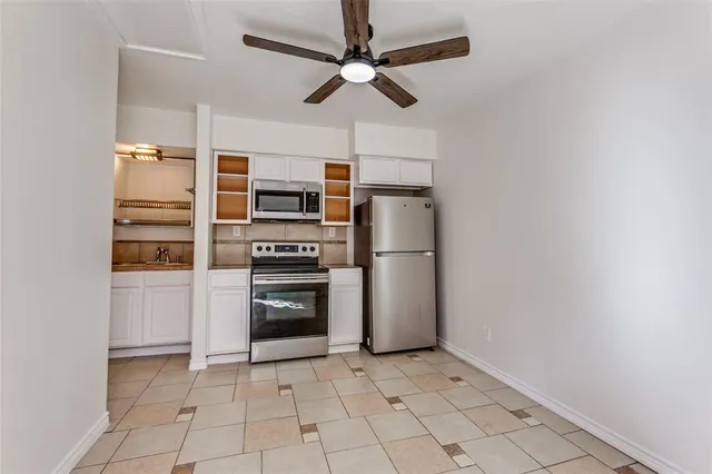 a kitchen with stainless steel appliances a refrigerator and a stove top oven