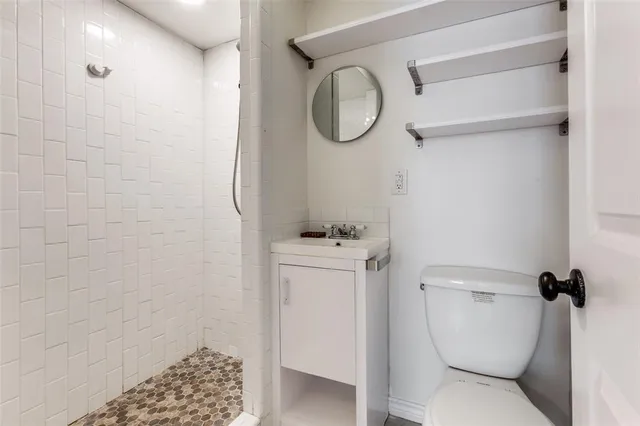 a bathroom with a toilet and a shower
