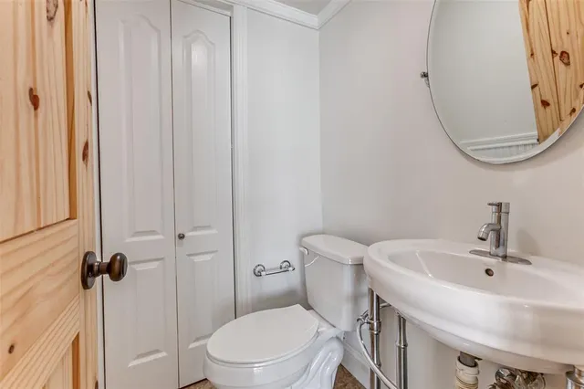 a white toilet sitting next to a bathroom sink