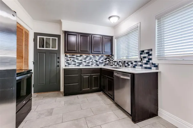 a kitchen with a stove sink and refrigerator