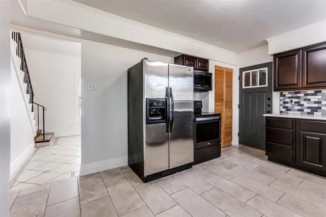 a kitchen with granite countertop a refrigerator and a stove