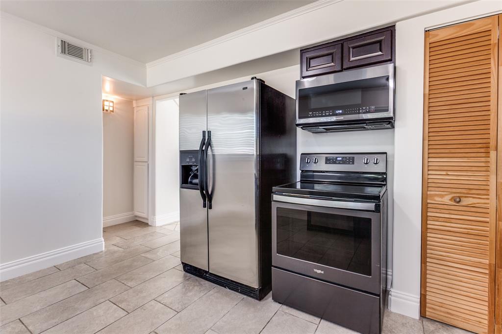 110 Ocean Drive Richardson, TX 75081 - Photo 7 of 20 a kitchen with a refrigerator stove and microwave