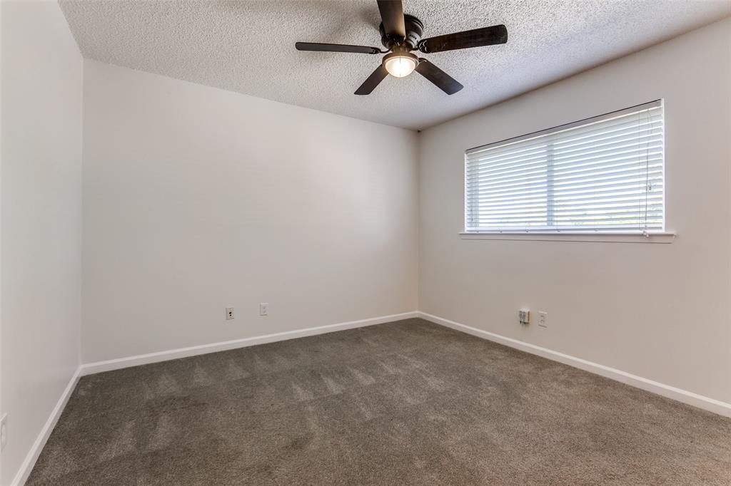 110 Ocean Drive Richardson, TX 75081 - Photo 8 of 20 an empty room with a window and a fan