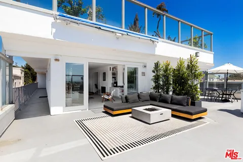 a view of a patio with swimming pool table and chairs