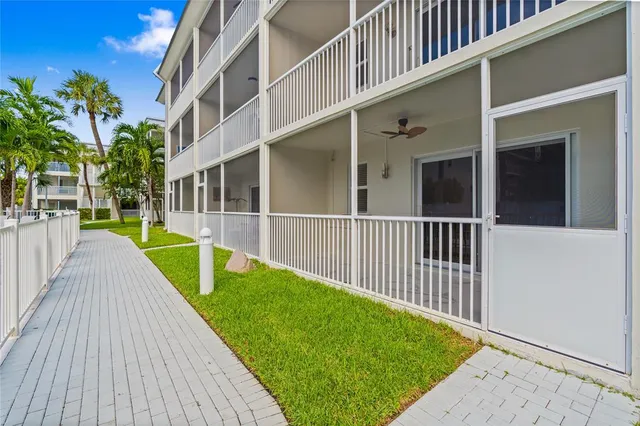 a kitchen with stainless steel appliances granite countertop white cabinets granite counter tops and a window