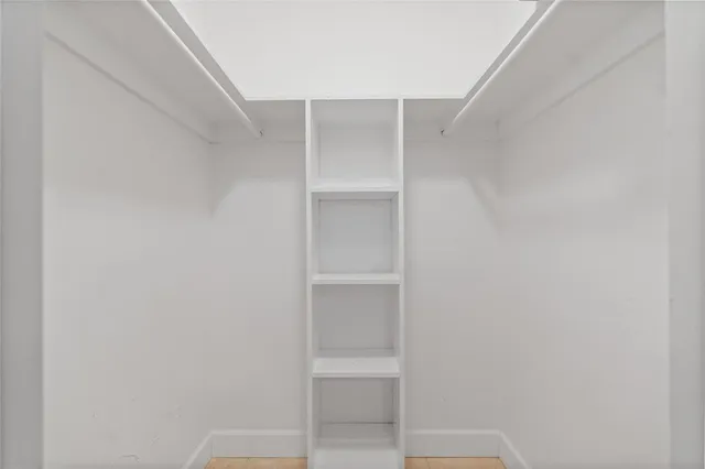 a swimming pool with outdoor seating and a potted plant