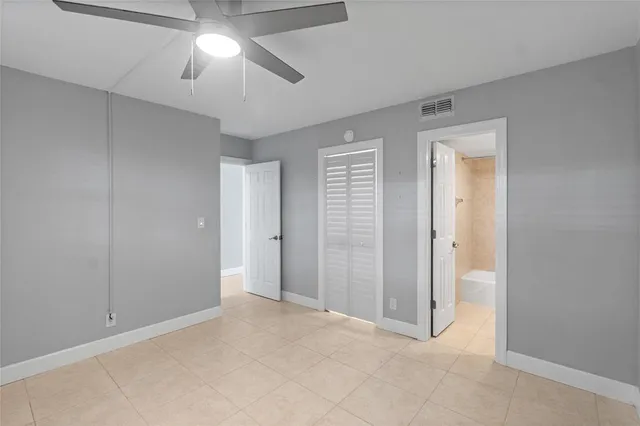 a view of a swimming pool with lawn chairs and a big yard