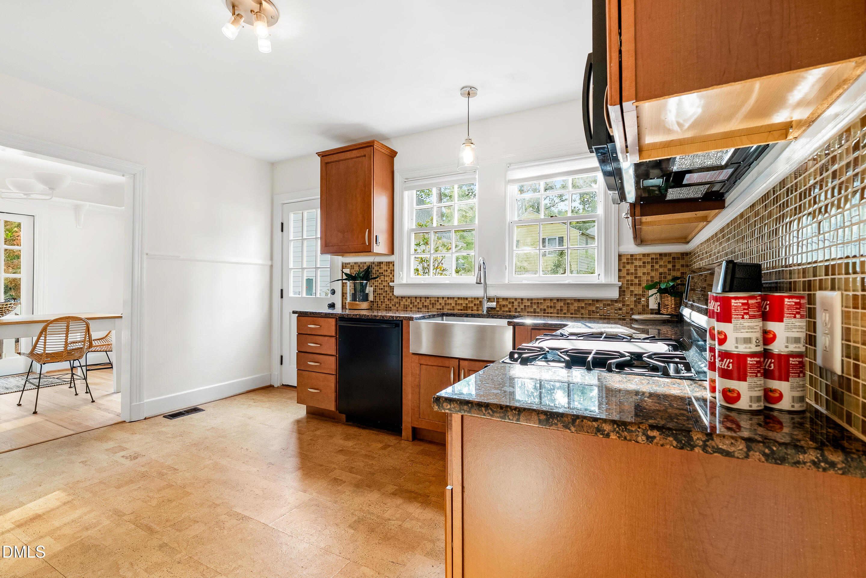 1702 James Street Durham, NC 27707 - Photo 11 of 21 a kitchen with stainless steel appliances granite countertop a stove and a refrigerator