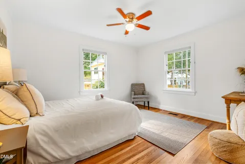 a bedroom with a bed and wooden floor