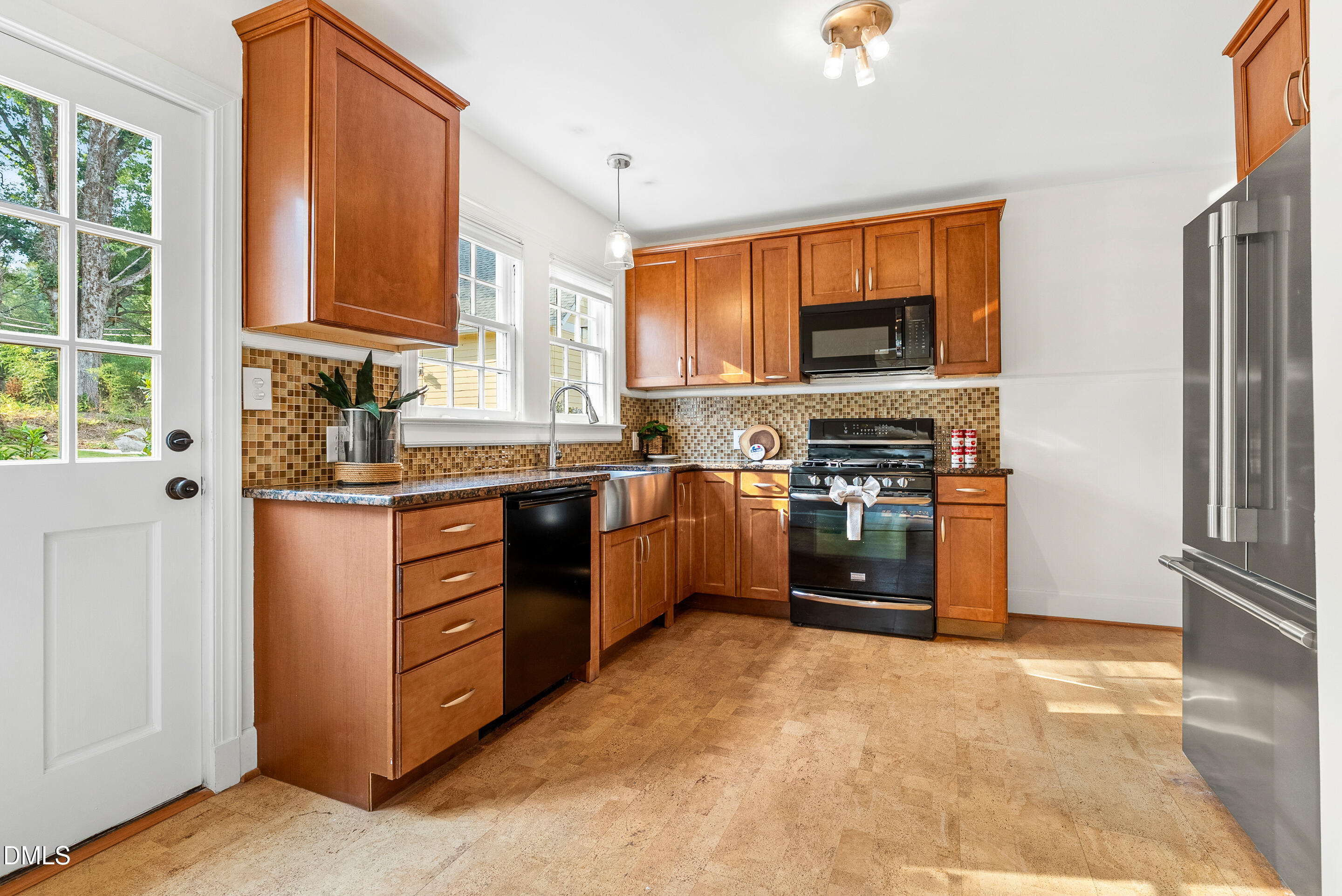 1702 James Street Durham, NC 27707 - Photo 10 of 21 a kitchen with stainless steel appliances granite countertop a stove top oven a refrigerator and a sink with granite countertops