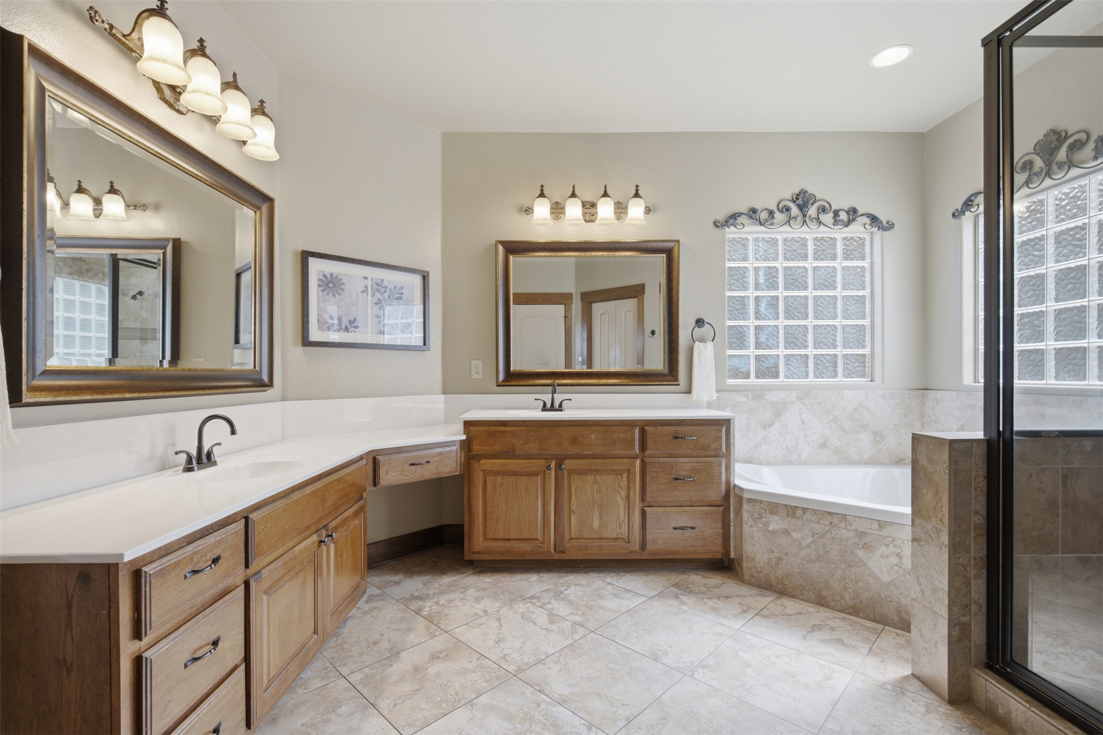 700 Augusta Circle Point Venture, TX 78645 - Photo 11 of 35 A spacious bathroom showcases dual vanities, a deep soaking tub, and a separate glass-enclosed shower.