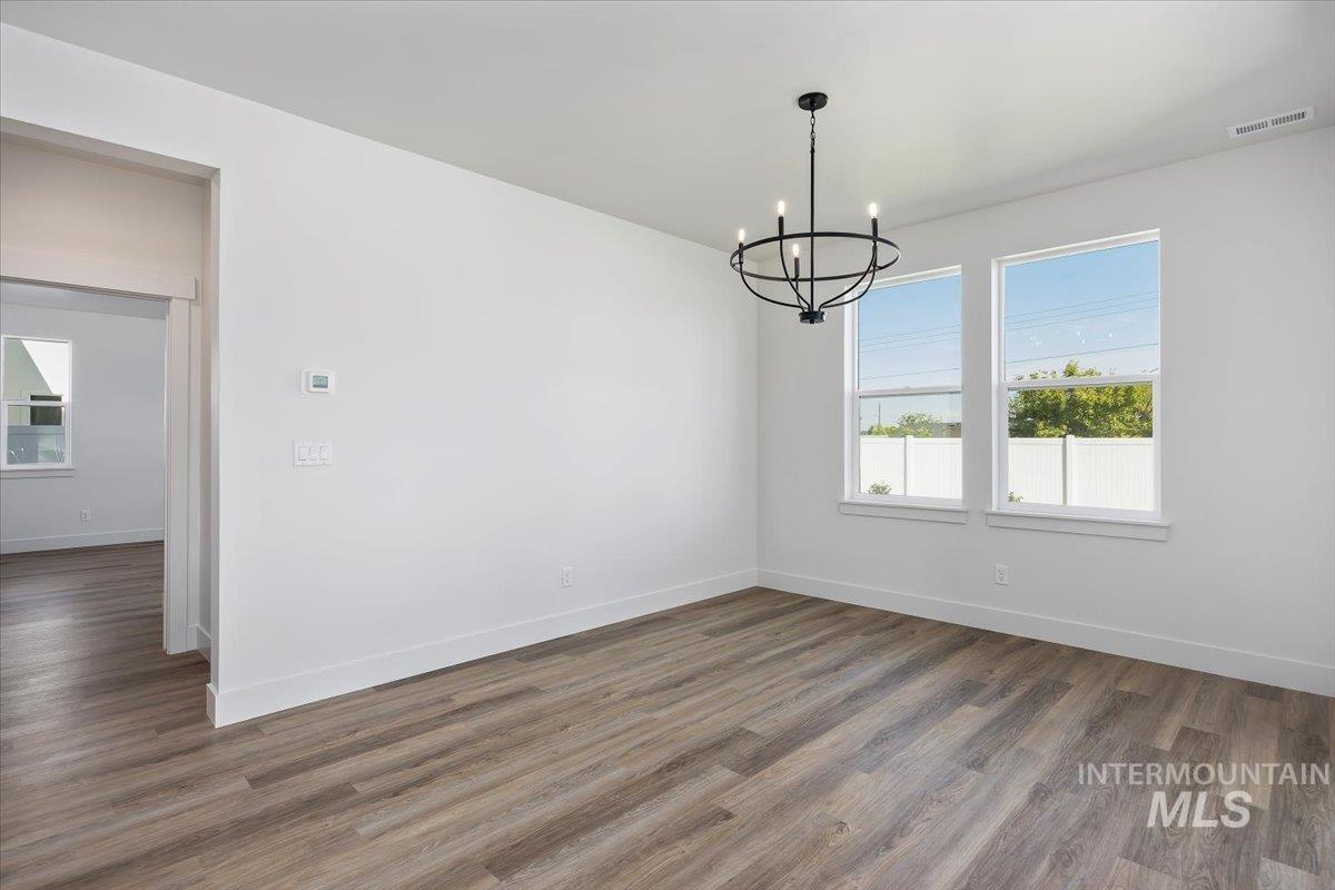 178 Maxine Lane, Unit HOMESITE 204 Kimberly, ID 83341 - Photo 11 of 24 Unfurnished dining area with wood-style floors and a chandelier 12'x13x