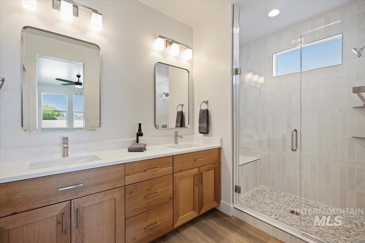 178 Maxine Lane, Unit HOMESITE 204 Kimberly, ID 83341 - Photo 15 of 24 Full bath featuring a shower stall with bench, double vanity, light wood-type flooring.
