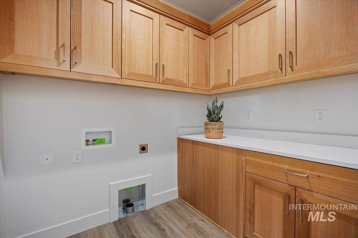 178 Maxine Lane, Unit HOMESITE 204 Kimberly, ID 83341 - Photo 17 of 24 Washroom featuring wood finished floors, washer hookup, cabinet space, and electric dryer hookup
