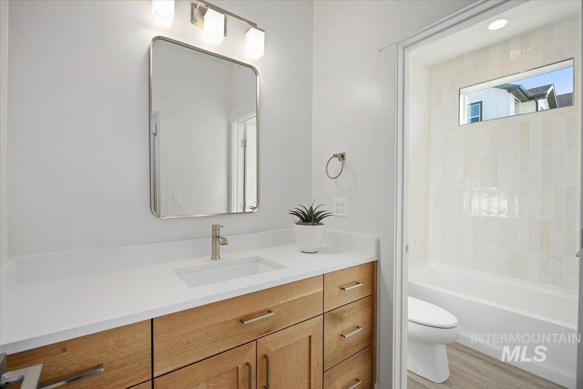 178 Maxine Lane, Unit HOMESITE 204 Kimberly, ID 83341 - Photo 20 of 24 Bathroom with vanity, light wood-type flooring, and shower / bath combination
