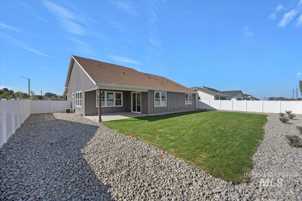 178 Maxine Lane, Unit HOMESITE 204 Kimberly, ID 83341 - Photo 21 of 24 Rear view of house featuring a covered patio area, a fenced landscaped backyard