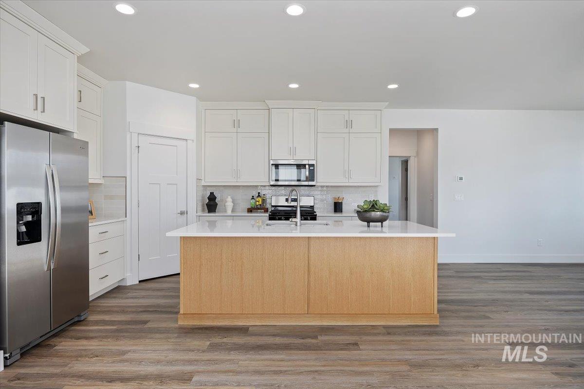 178 Maxine Lane, Unit HOMESITE 204 Kimberly, ID 83341 - Photo 4 of 24 Kitchen with appliances with stainless steel finishes, dark wood-type flooring, recessed lighting, backsplash, and white cabinetry