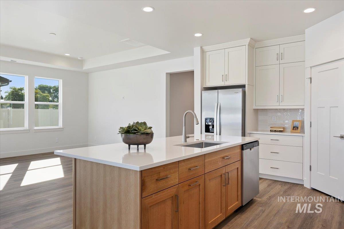 178 Maxine Lane, Unit HOMESITE 204 Kimberly, ID 83341 - Photo 6 of 24 Kitchen featuring recessed lighting, appliances with stainless steel finishes, dark wood-type flooring, decorative backsplash, and brown cabinetry