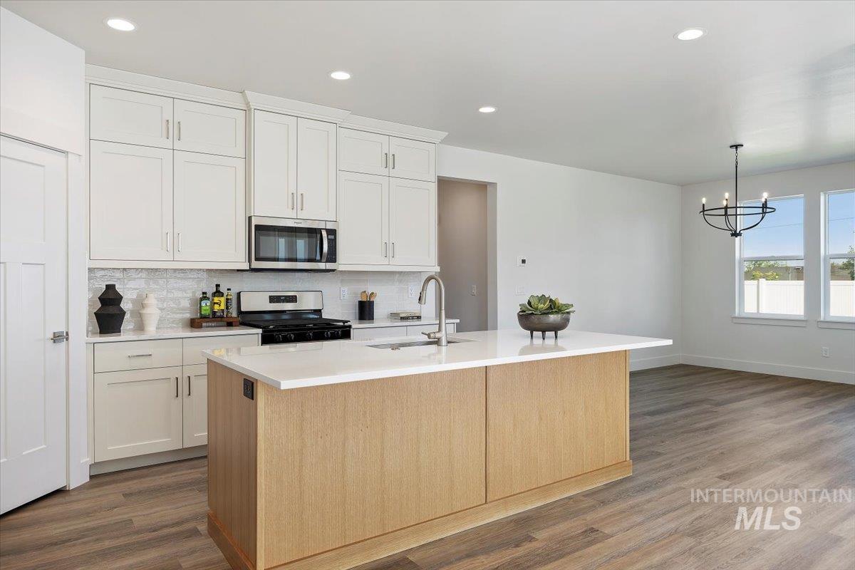 178 Maxine Lane, Unit HOMESITE 204 Kimberly, ID 83341 - Photo 7 of 24 Kitchen with recessed lighting, appliances with stainless steel finishes, decorative backsplash, a center island with sink, and dark wood finished floors