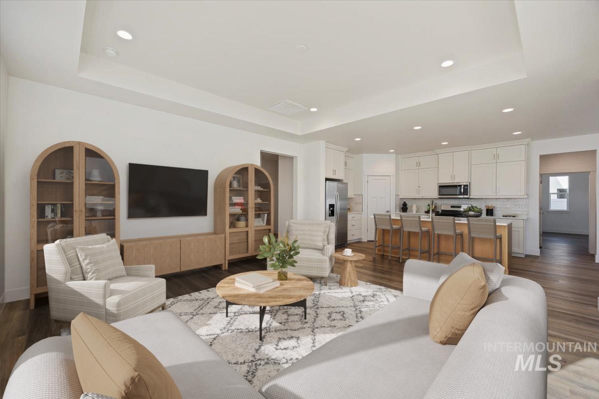 178 Maxine Lane, Unit HOMESITE 204 Kimberly, ID 83341 - Photo 9 of 24 Living area with a raised ceiling, recessed lighting, and dark wood finished floors