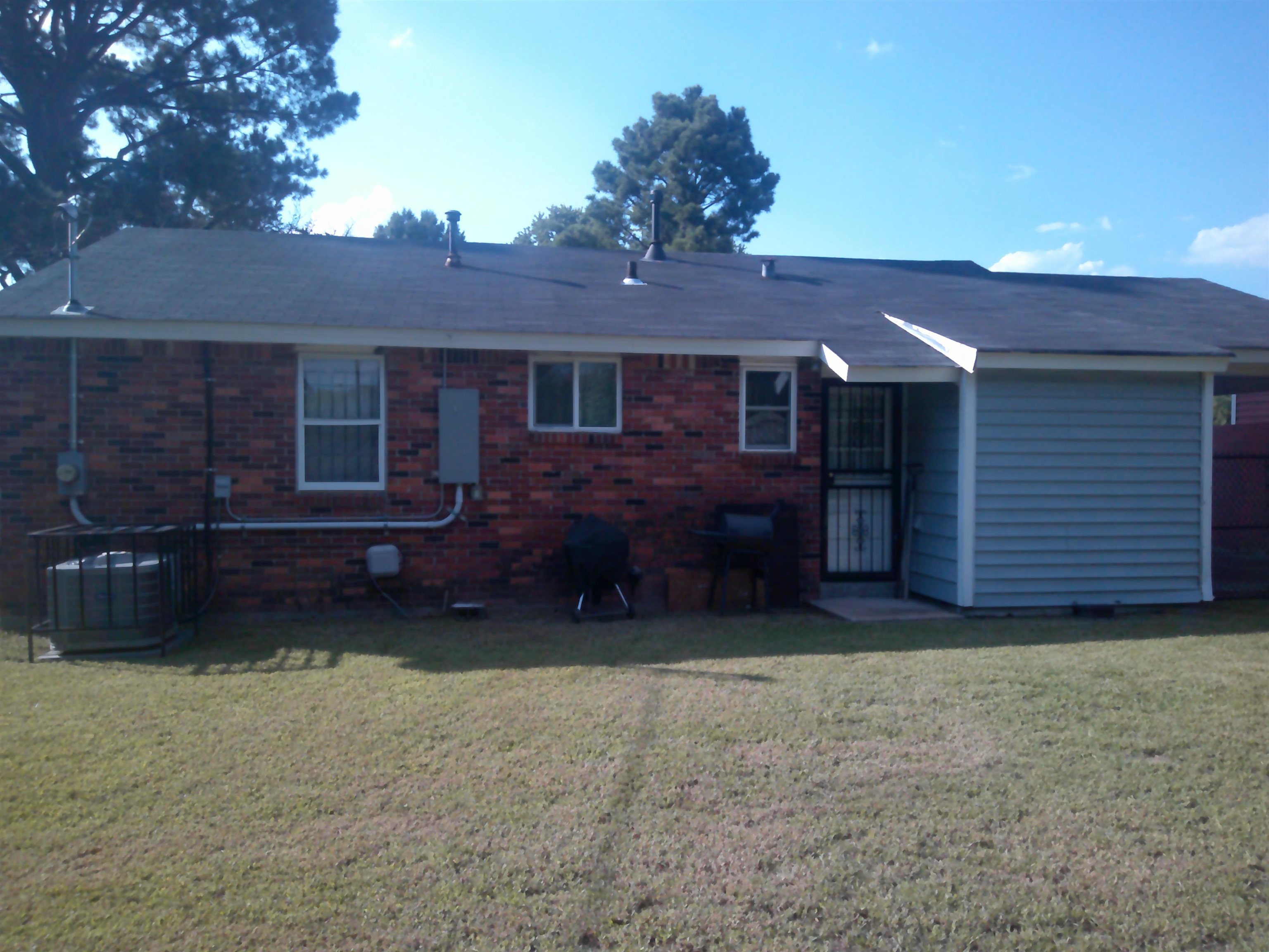 4374 Ford Road Memphis, TN 38109 - Photo 12 of 14 a view of a house with a yard plants and large tree