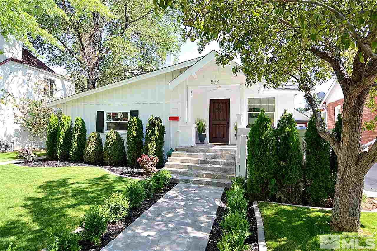 574 Reno Avenue Reno, NV 89509 - Photo 1 of 1 a view of a white house with a big yard and potted plants and large trees