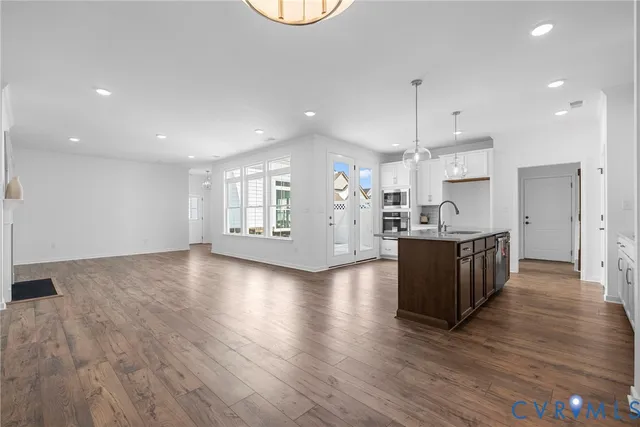 a view of kitchen with kitchen island and stainless steel appliances