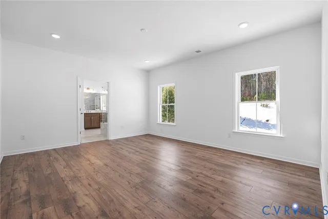 an empty room with windows and entrance