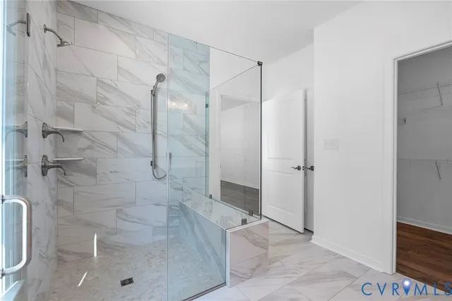 a bathroom with a shower and a glass door