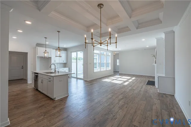 a large kitchen with granite countertop a large counter top appliances and cabinets