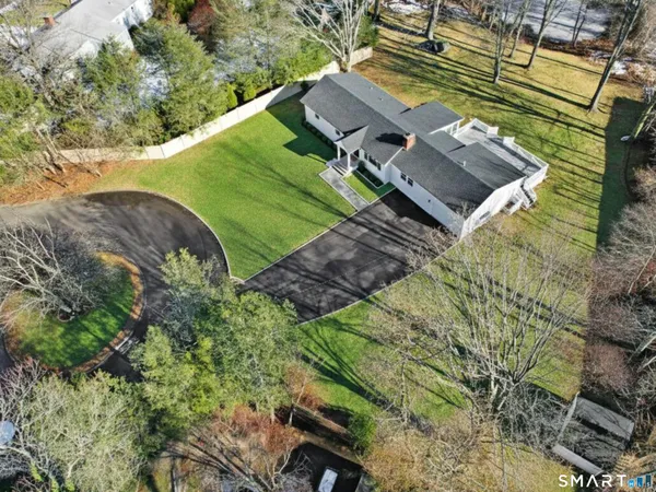 an aerial view of a house with a yard