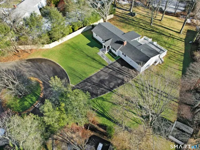 an aerial view of a house with a yard